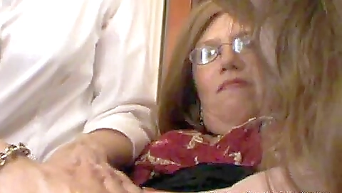 Two mature stepmothers seduce a young boy in this scene